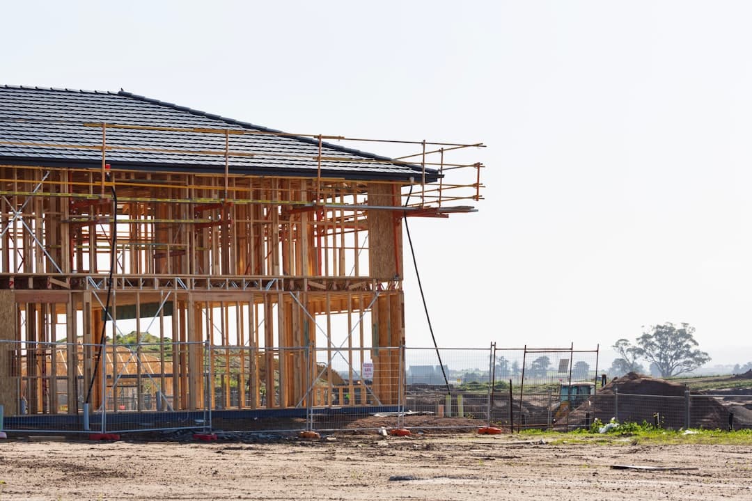 New home under construction with scaffolding and exposed framing