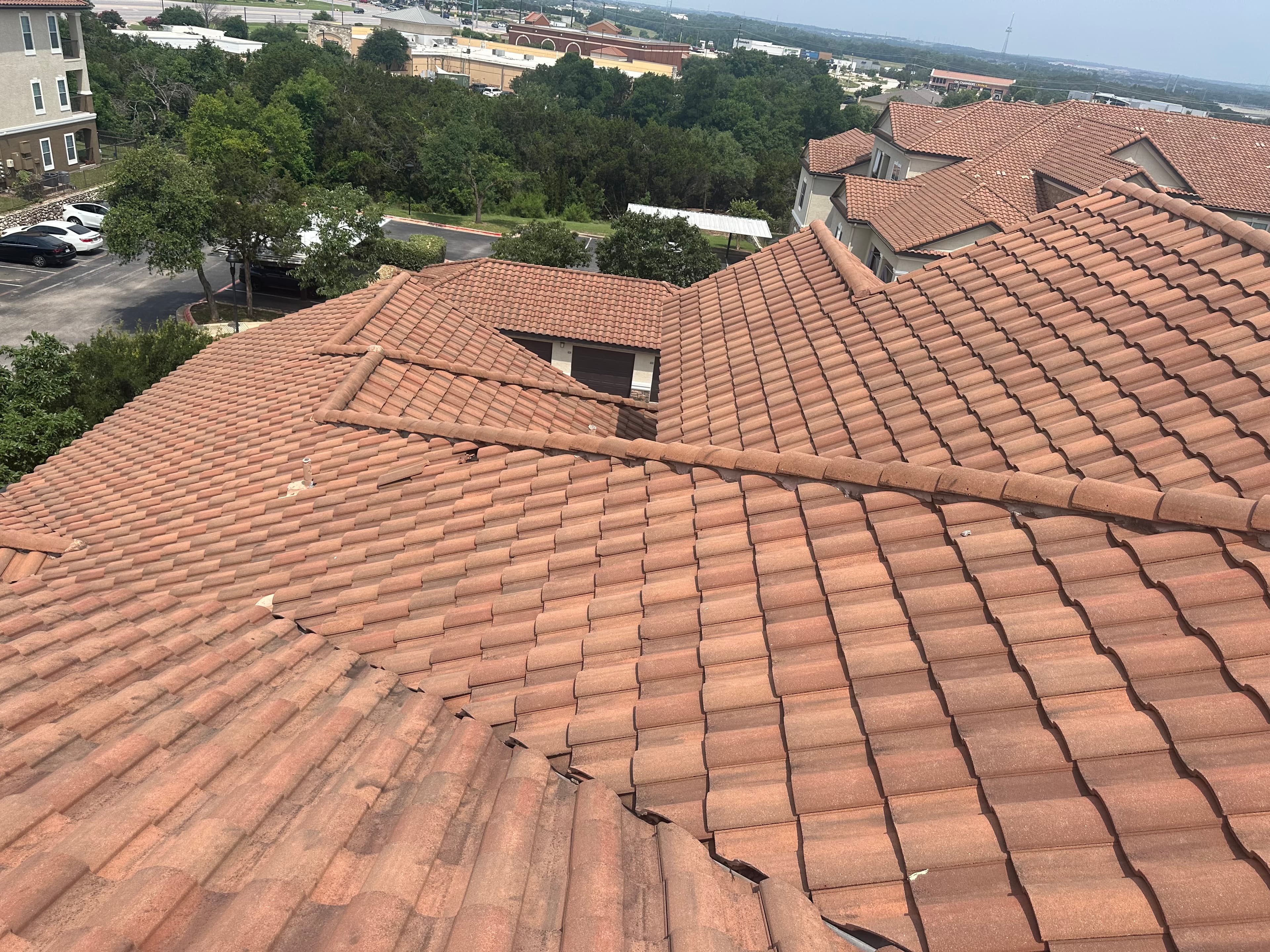 Aerial inspection photo of a tile roof showing cracked and displaced tiles